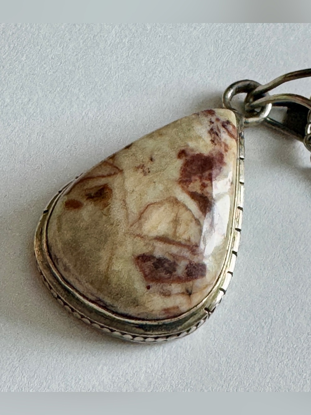 Garnet in Limestone stone set in a sterling silver pendant. 